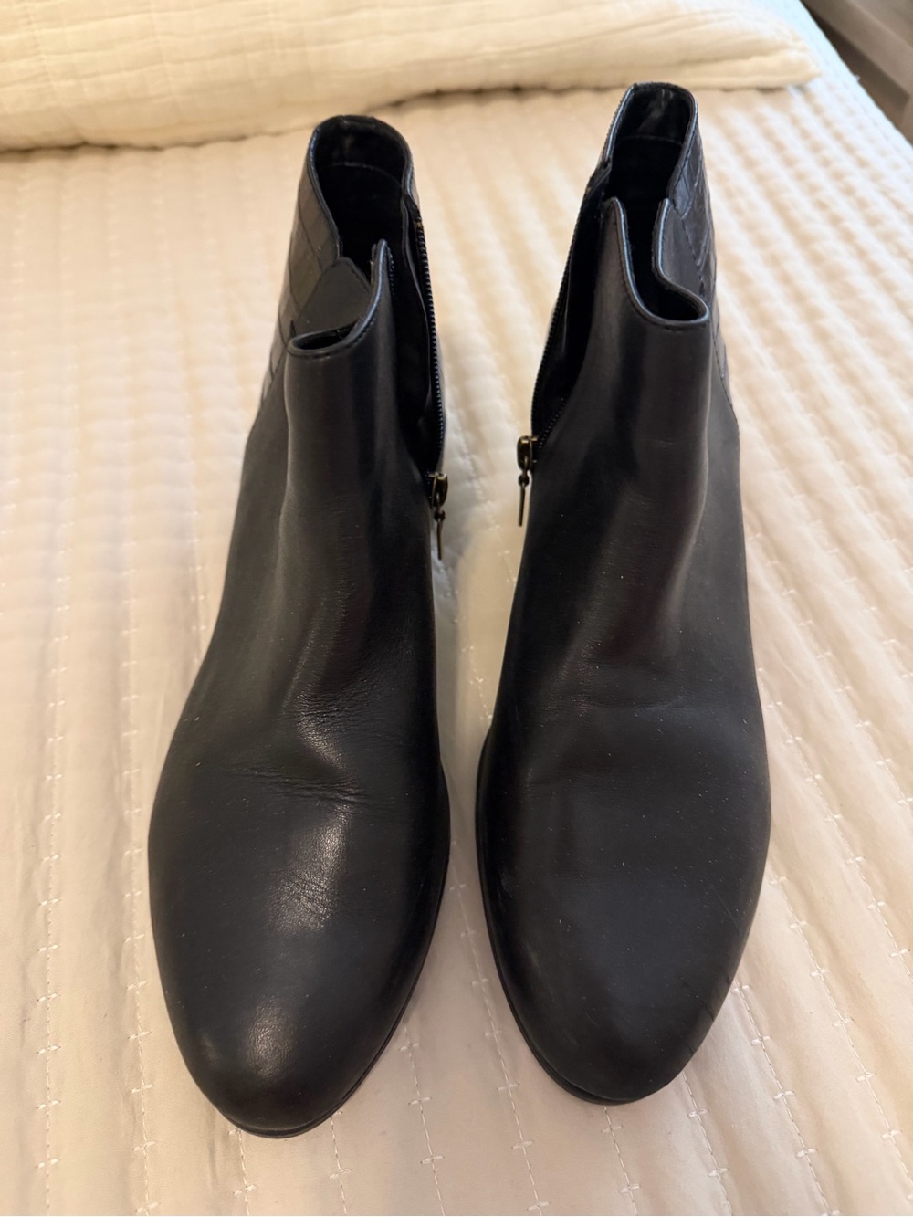 Clarks Black Leather Ankle Booties with Side Zipper. Heel detail